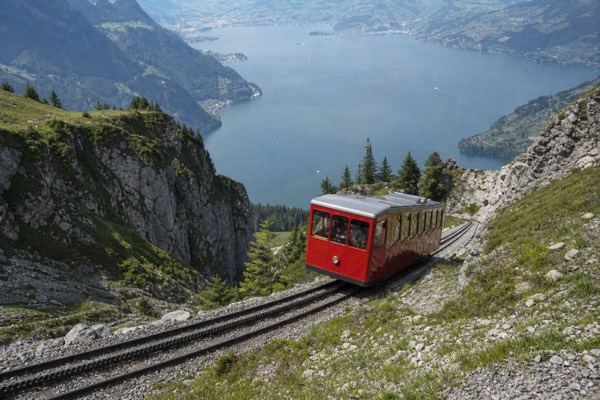 A cogwheel railway carriage climbing the steep Mount Pilatus rack track above Lake Lucerne